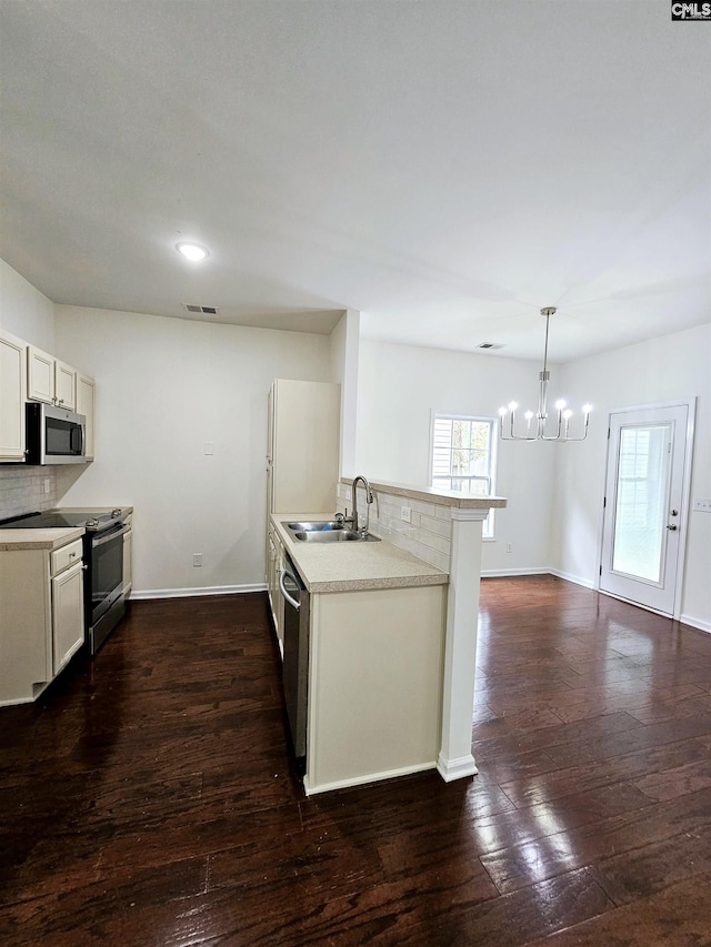 kitchen featuring visible vents, dark wood finished floors, light countertops, appliances with stainless steel finishes, and a sink