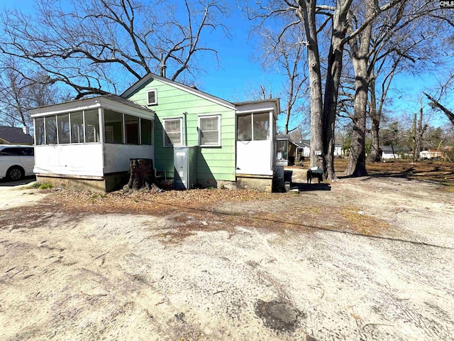 view of front of home featuring a sunroom