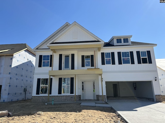 view of front facade with brick siding, driveway, and a garage