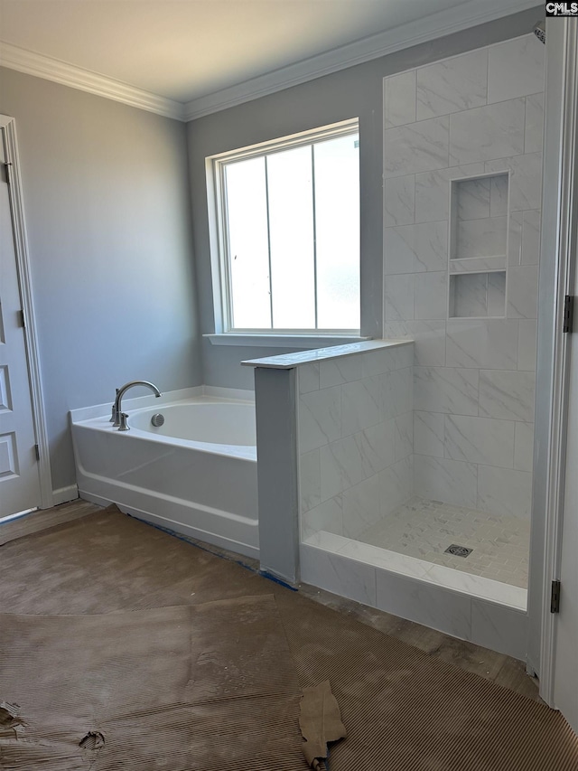 bathroom with a garden tub, a tile shower, and ornamental molding