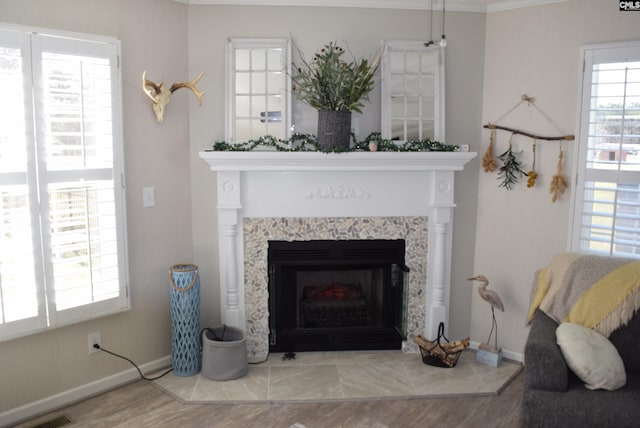 details featuring a tiled fireplace, visible vents, and baseboards