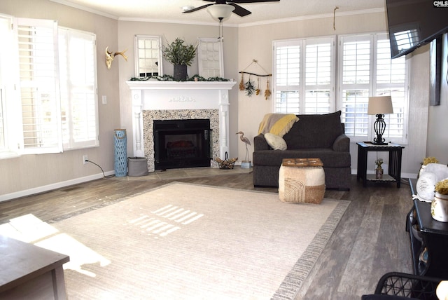 living room with plenty of natural light, wood finished floors, and crown molding