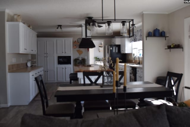 dining area with ceiling fan and wood finished floors