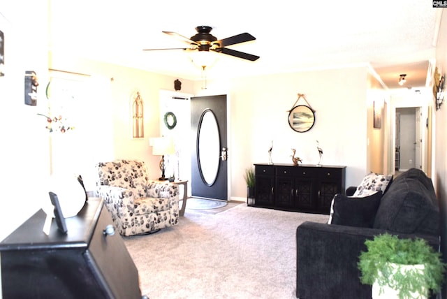 carpeted living area featuring a ceiling fan and baseboards