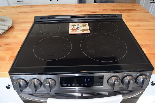 room details featuring electric stove and wood counters