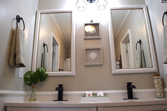 bathroom featuring ornamental molding, a textured ceiling, and a sink