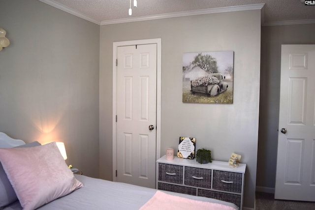 bedroom with a textured ceiling and crown molding