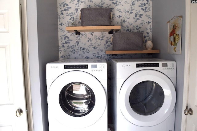 washroom with washing machine and clothes dryer, laundry area, and wallpapered walls