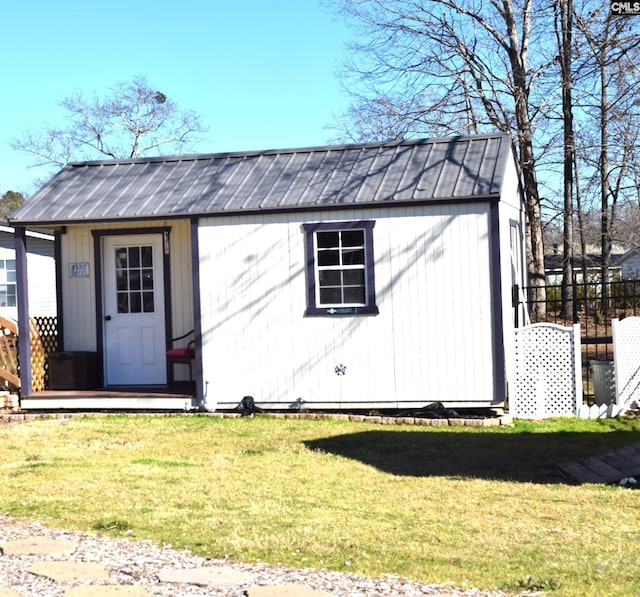 view of outbuilding featuring an outdoor structure and fence