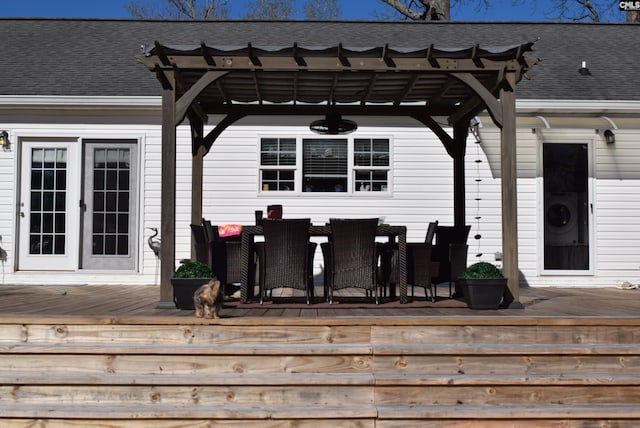 wooden terrace featuring french doors, outdoor dining area, and a pergola