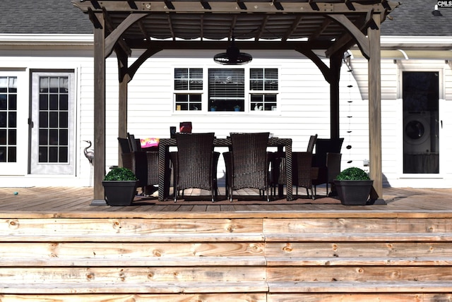 wooden deck featuring washer / dryer and a pergola