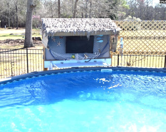 outdoor pool featuring fence