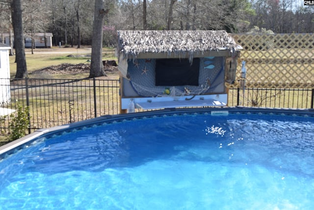 view of swimming pool featuring a fenced in pool and fence