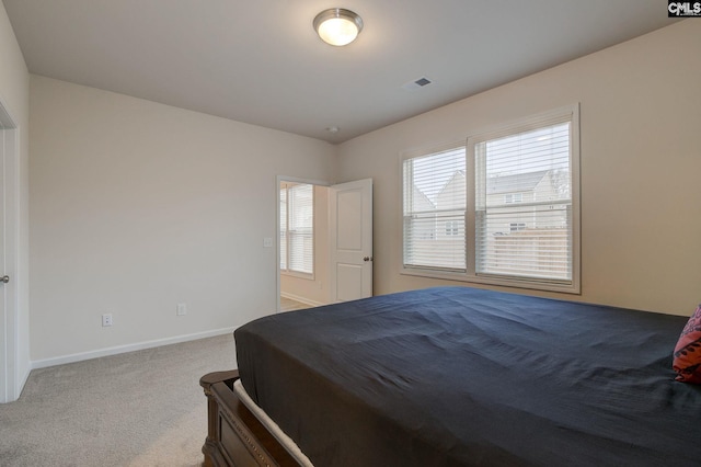 carpeted bedroom featuring baseboards and visible vents