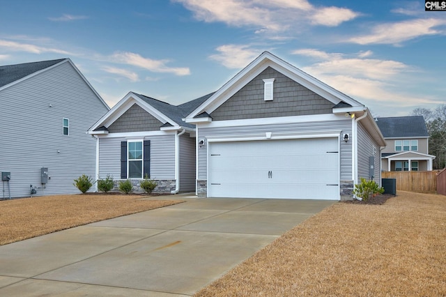 craftsman inspired home with a garage, stone siding, concrete driveway, and a front yard