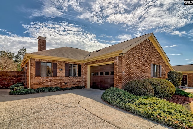 single story home featuring fence, a chimney, concrete driveway, a garage, and brick siding