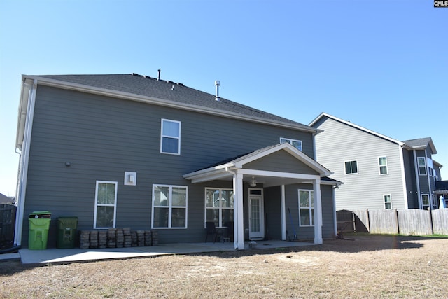 rear view of house with a patio and fence