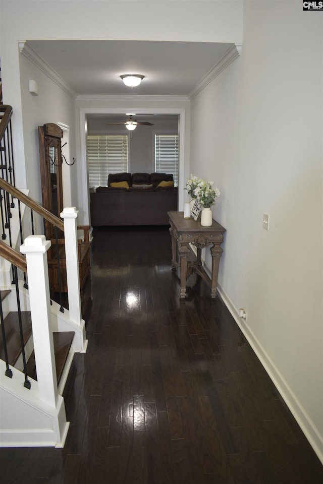 hallway featuring stairs, baseboards, wood-type flooring, and ornamental molding