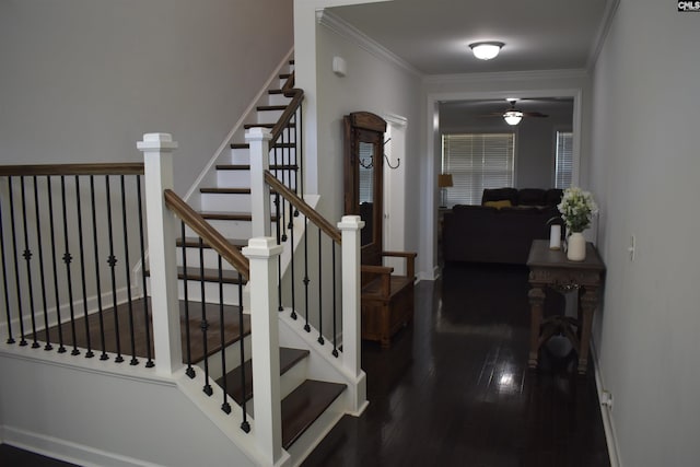 stairway with baseboards, a ceiling fan, wood finished floors, and crown molding