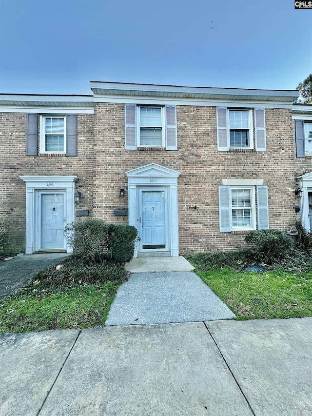 view of property featuring brick siding