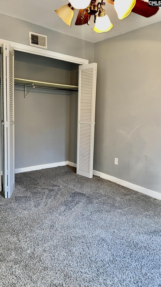 unfurnished bedroom featuring a closet, visible vents, a ceiling fan, and baseboards