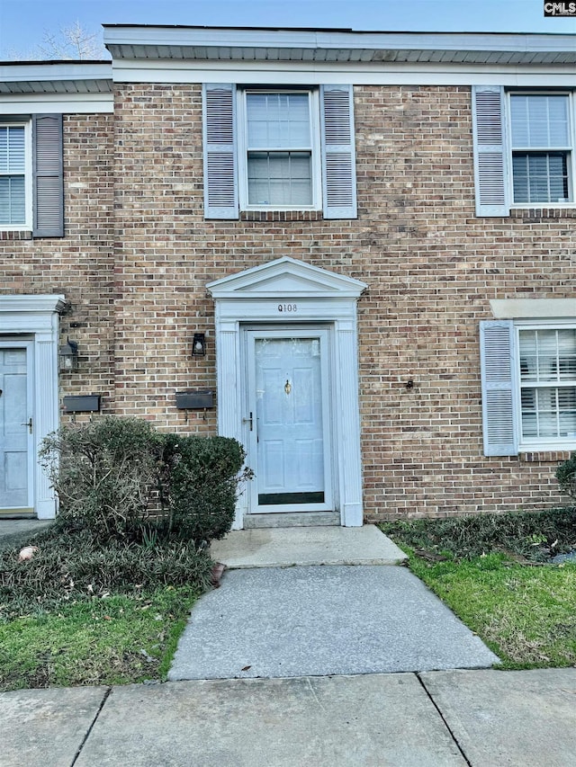 entrance to property with brick siding