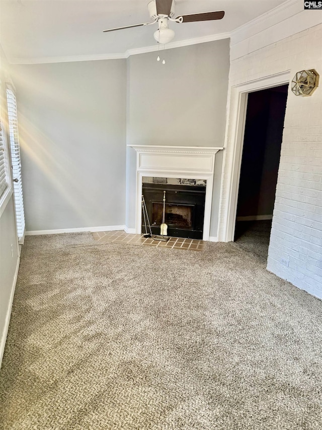 unfurnished living room with baseboards, a fireplace with flush hearth, ceiling fan, ornamental molding, and carpet flooring