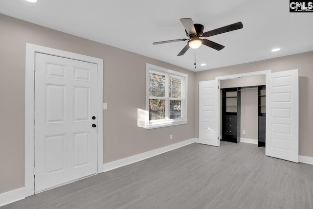 interior space with recessed lighting, wood finished floors, baseboards, and ceiling fan