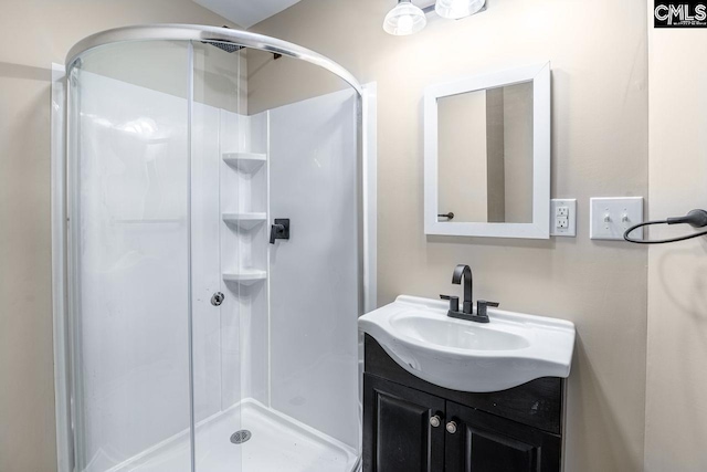 bathroom with a stall shower and vanity