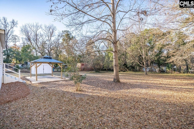 view of yard featuring a gazebo, a detached carport, and fence