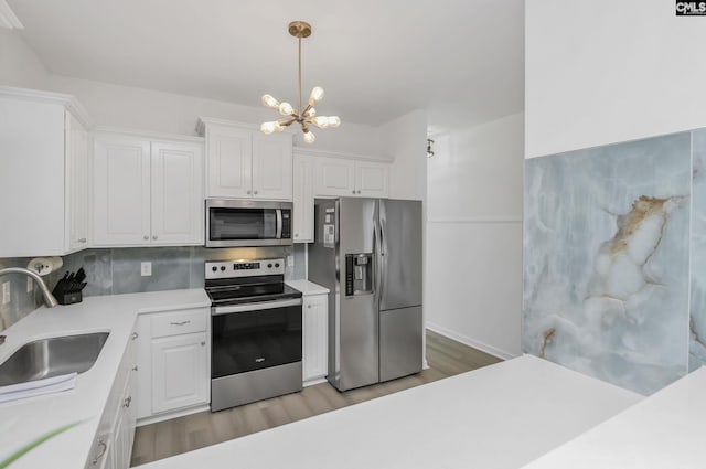 kitchen featuring a sink, light countertops, white cabinets, and stainless steel appliances