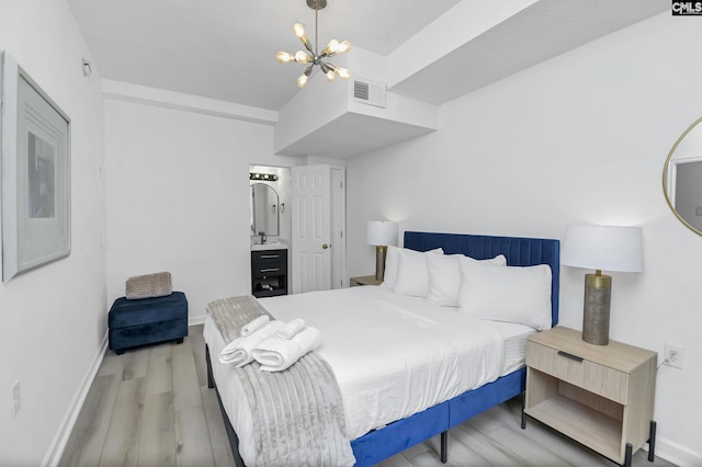 bedroom with a notable chandelier, visible vents, baseboards, and light wood-style floors