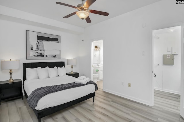 bedroom with light wood-style flooring, connected bathroom, baseboards, and a ceiling fan