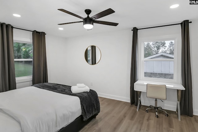 bedroom featuring recessed lighting, multiple windows, and light wood-style flooring