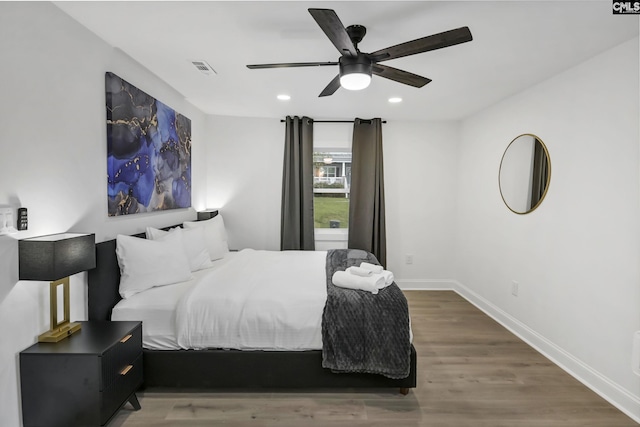 bedroom with wood finished floors, visible vents, baseboards, recessed lighting, and ceiling fan