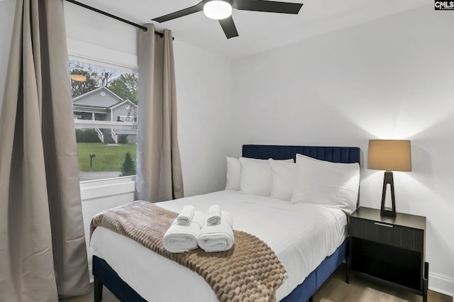 bedroom with light wood finished floors and a ceiling fan