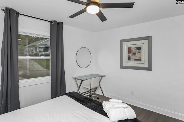 bedroom with dark wood finished floors, ceiling fan, and baseboards