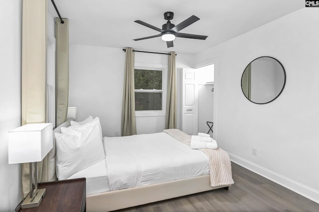 bedroom with ceiling fan, baseboards, and wood finished floors