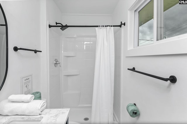 full bathroom with vanity and a shower stall