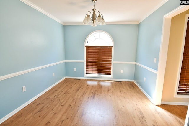 unfurnished room with baseboards, wood finished floors, and crown molding