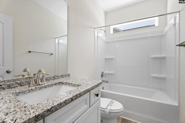 bathroom featuring vanity, toilet, and shower / bathtub combination