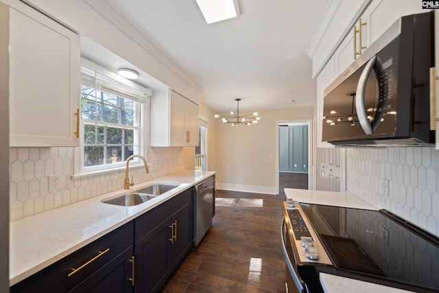 kitchen featuring white cabinetry, dark wood-style floors, appliances with stainless steel finishes, and a sink