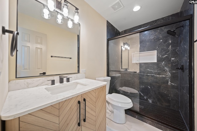 bathroom featuring vanity, toilet, visible vents, and a marble finish shower