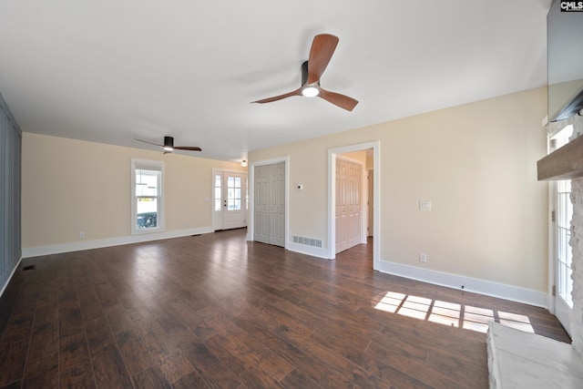 unfurnished living room with visible vents, french doors, baseboards, and wood finished floors