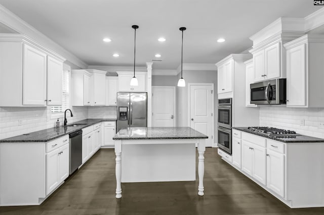 kitchen featuring appliances with stainless steel finishes, white cabinetry, dark wood-type flooring, and a sink