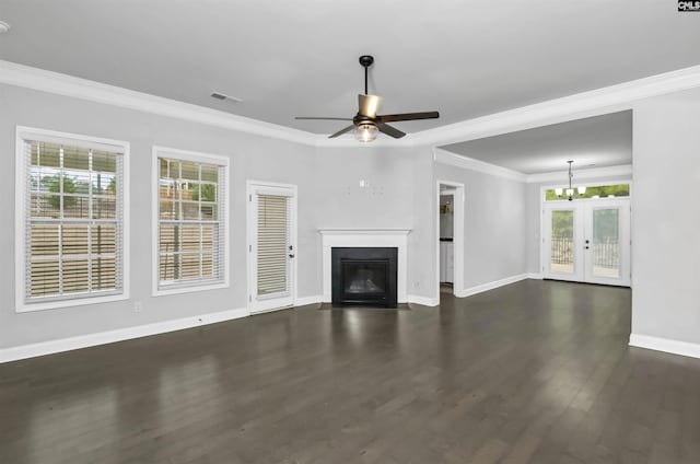 unfurnished living room with dark wood-type flooring, crown molding, a fireplace with flush hearth, and a healthy amount of sunlight