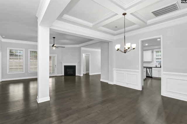 unfurnished living room with visible vents, a healthy amount of sunlight, a fireplace, and ceiling fan with notable chandelier