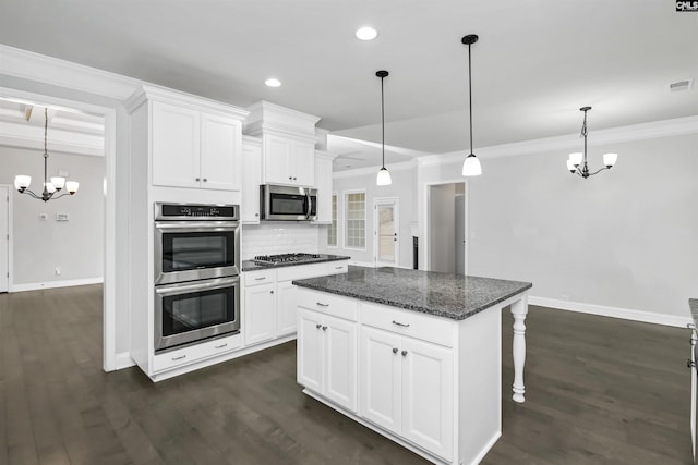 kitchen with ornamental molding, decorative backsplash, dark wood-style floors, a notable chandelier, and stainless steel appliances