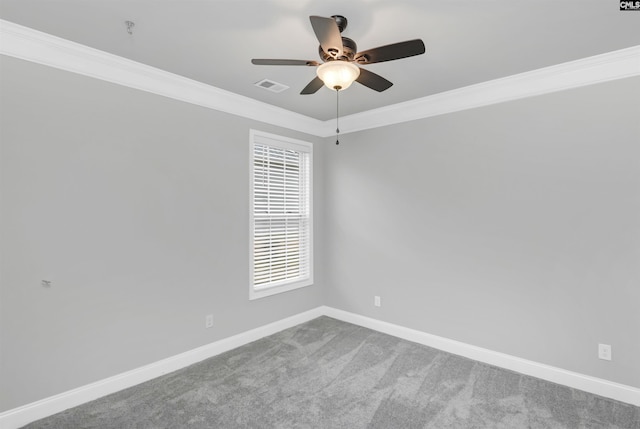 unfurnished room with visible vents, carpet floors, baseboards, and crown molding