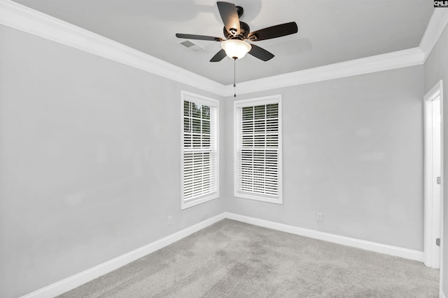 carpeted empty room featuring visible vents, plenty of natural light, crown molding, baseboards, and ceiling fan